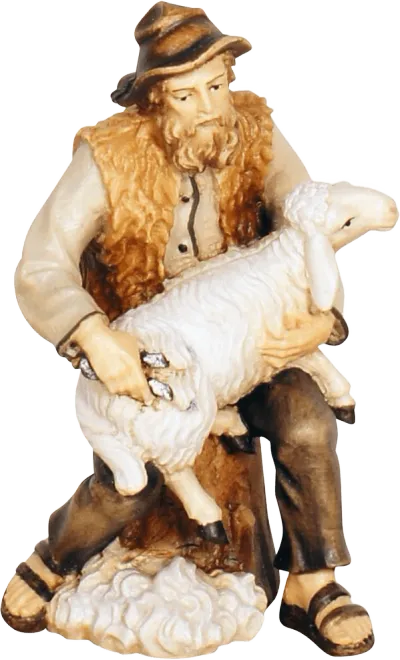 Hand-carved wooden shepherd figure shearing a white sheep, painted in natural colors
