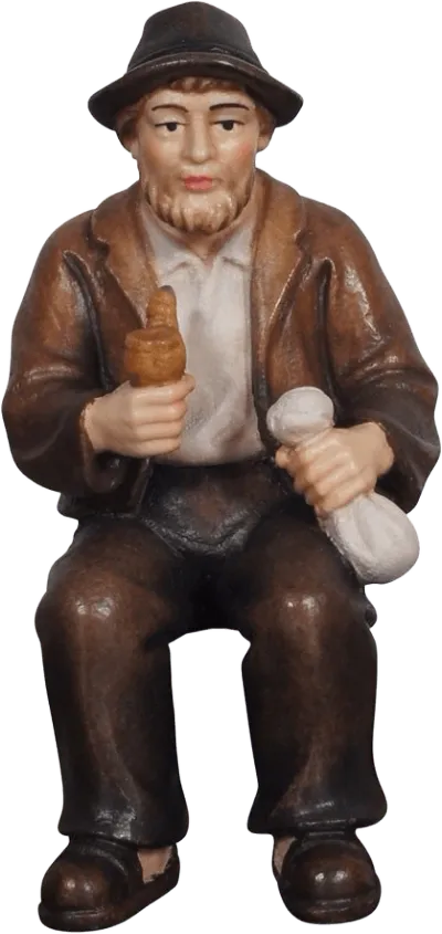 Hand-carved wooden figure of seated grandfather with brown jacket and hat holding two objects
