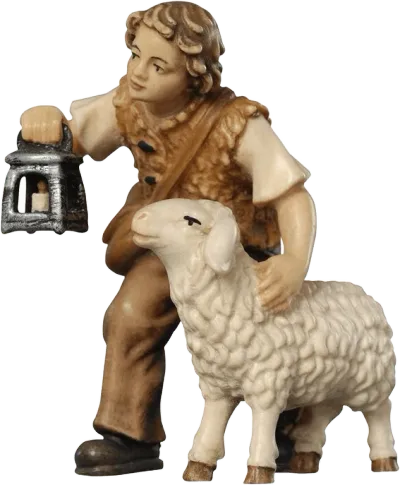 Hand-carved wooden figure of a boy holding a lantern with a sheep beside him, painted in natural tones