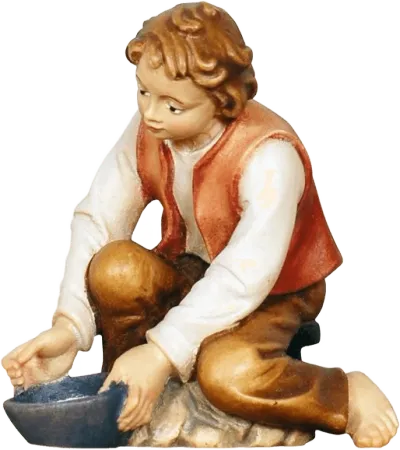 Hand-carved wooden figure of a boy milking, kneeling with a bowl, painted in natural colors